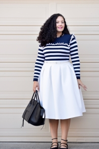 Tanesha Awasthi of Girl With Curves is wearing stripped sweater and white skirt.