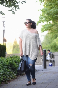 Tanesha Awasthi (formerly known as Girl with Curves) wearing an off the shoulder sweater, distressed jeans, flats and Celine Phantom at the park in Vancouver.