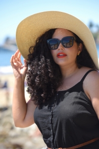 Tanesha Awasthi (formerly known as Girl With Curves) wearing a black shirtdress and floppy hat in Capitola.