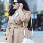 Tanesha Awasthi (Girl with Curves) wearing a trench coat, jeans and blue flats.