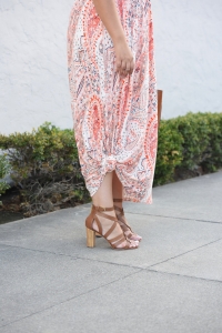Tanesha Awasthi (formerly Girl with Curves) wearing a paisley print maxi dress, heels, tote bag.