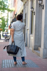 Tanesha Awasthi (formerly known as Girl with Curves) wearing a stripe shirtdress, skiny jeans and Celine Phantom in Gastown, Vancouver.