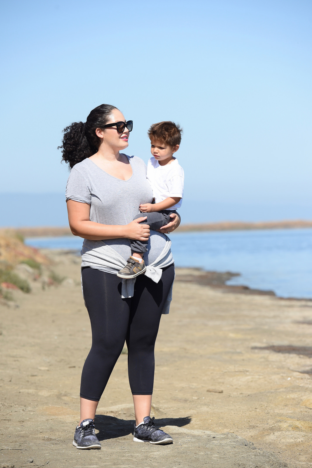 Tanesha Awasthi (formerly known as Girl with Curves) wearing workout clothing with her son at the Alviso Marina County Park in the San Francisco Bay Area.