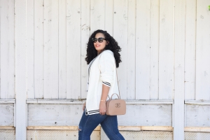 Tanesha Awasthi, also known as Girl With Curves, wearing a preppy cardigan, jeans and Chanel bag.
