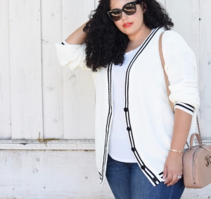 Tanesha Awasthi, also known as Girl With Curves, wearing a white tee, plus size skinny jeans, preppy cardigan, white sneakers and Chanel bag.