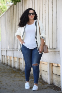 Tanesha Awasthi, also known as Girl With Curves, wearing a white tee, plus size skinny jeans, white sneakers and Chanel bag.