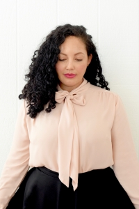 Tanesha Awasthi, also known as Girl With Curves, shares 1 of 3 ways to style a tie-neck blouse.