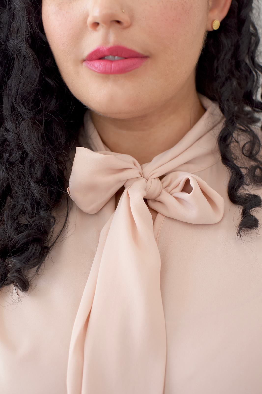 Tanesha Awasthi, also known as Girl With Curves, shares 1 of 3 ways to style a tie-neck blouse.