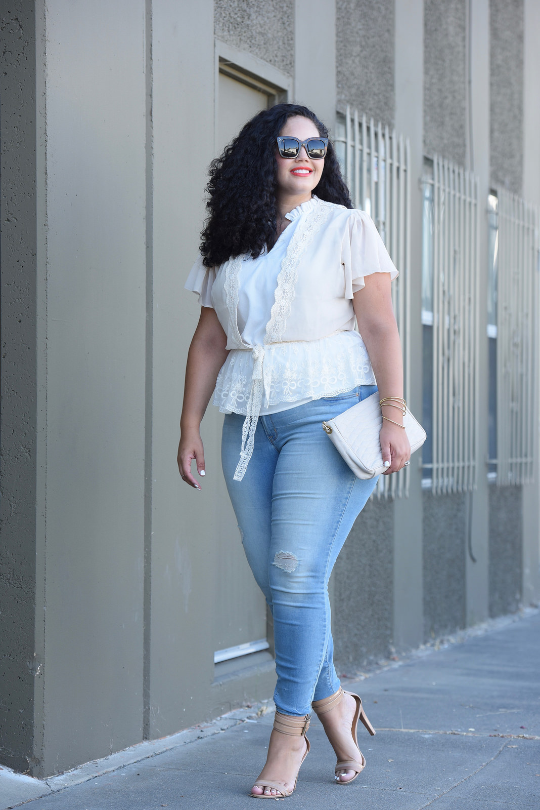 Tanesha Awasthi (also known as Girl With Curves) wearing plus size skinny jeans, lace cardigan and heels.