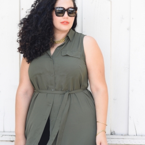 Tanesha Awasthi, also known as Girl With Curves, wearing a plus size shirtdress over leggings, Celine Audrey sunglasses and orange lipstick.