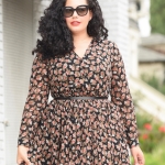 Tanesha Awasthi, also known as Girl with Curves, wearing a long sleeve plus size floral midi dress.