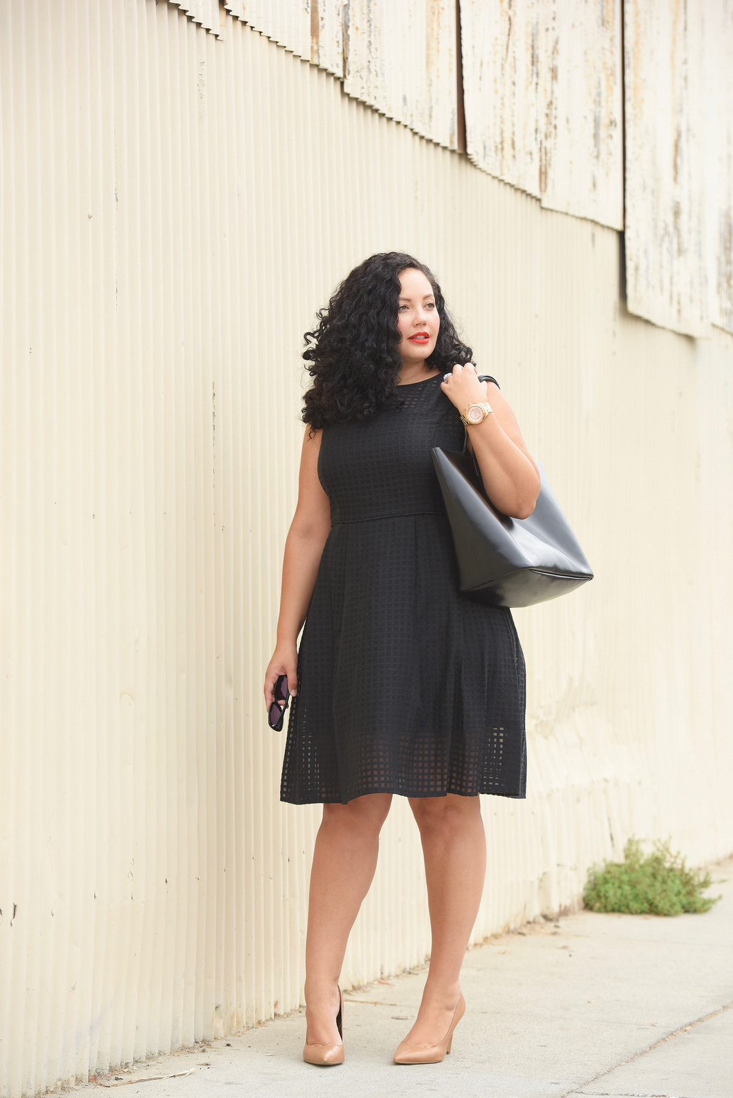 Tanesha Awasthi, also known as Girl With Curves, wearing a plus size gingham midi dress.