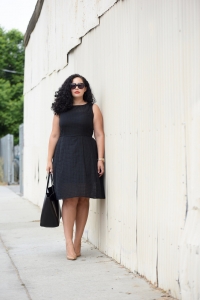 Tanesha Awasthi, also known as Girl With Curves, wearing a plus size gingham midi dress.