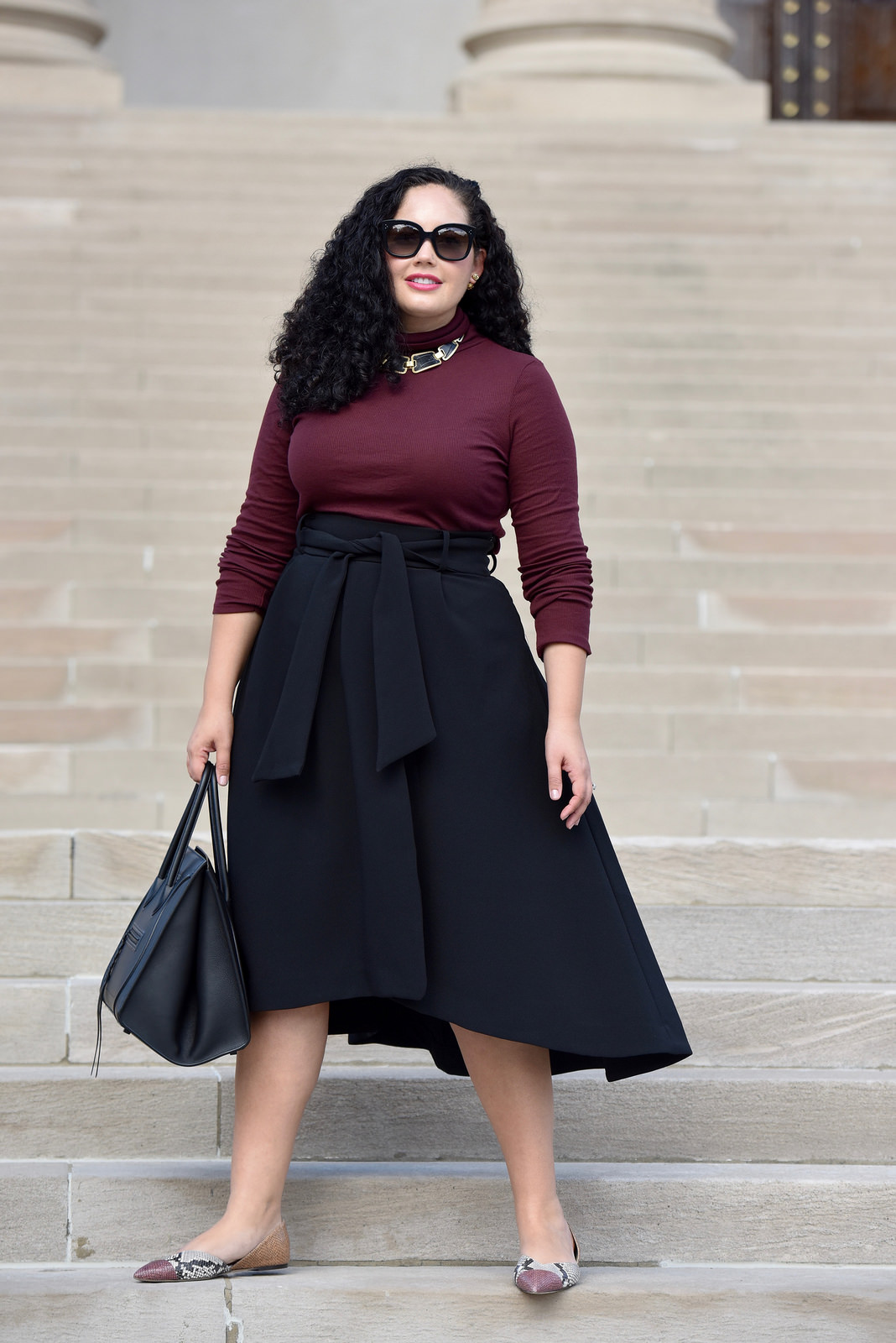 Burgundy Turtleneck, Waist Tie Midi Skirt, Snake print flats and Celine Phantom worn by Tanesha Awasthi, founder of Girl With Curves, at The White House
