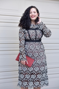Girl With Curves blogger Tanesha Awasthi wears a lace midi dress and red clutch.