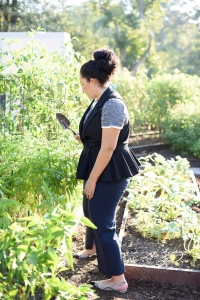 Tanesha Awasthi standing in the White House Kitchen Garden, established by Michelle Obama in 2009.