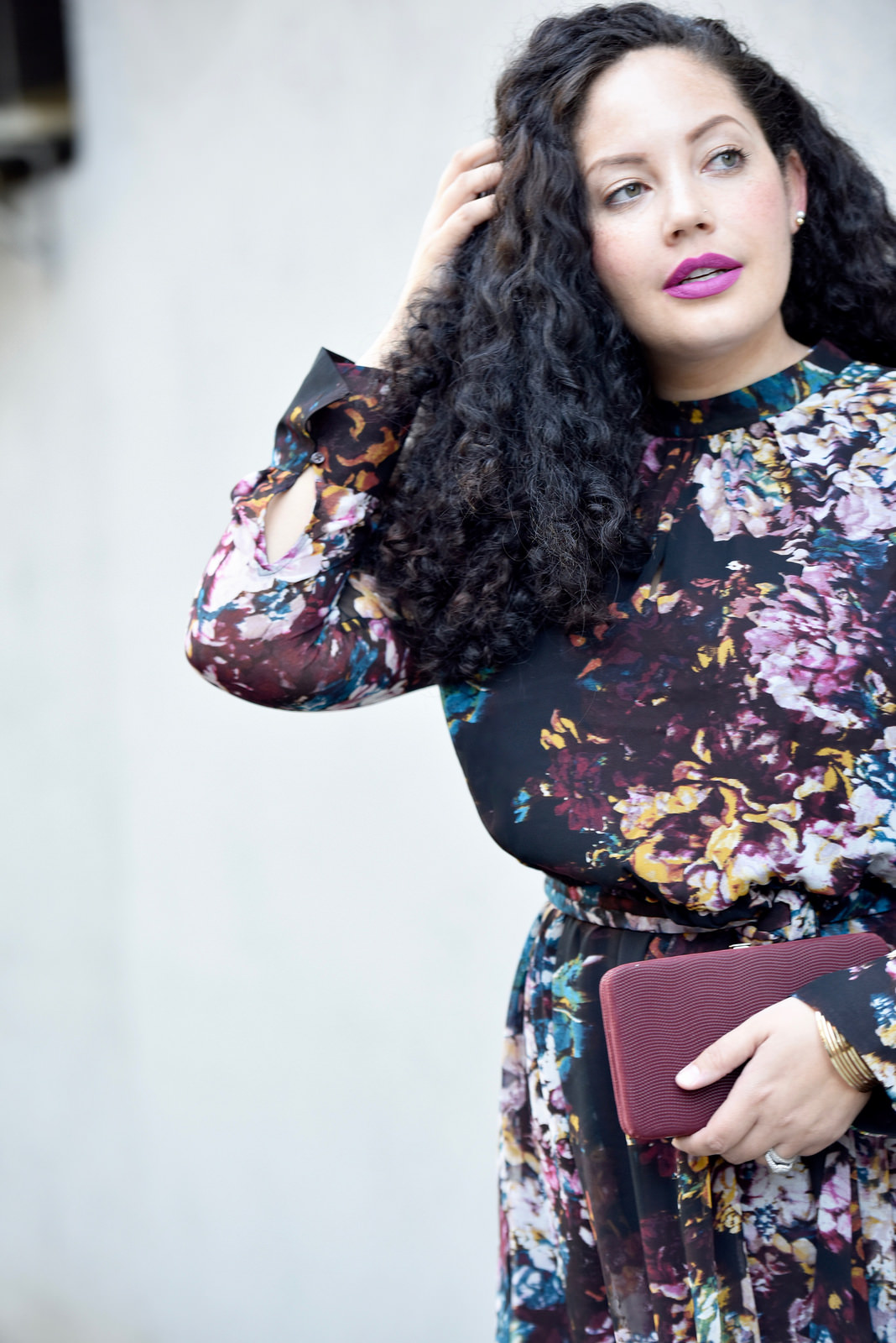 Girl With Curves blogger Tanesha Awasthi wears a long sleeve floral print dress midi dress.