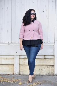 Girl With Curves blogger Tanesha Awasthi wears a pink cropped jacket, peplum top, skinny jeans and leopard flats.