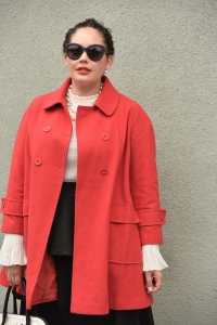 Girl With Curves blogger Tanesha Awasthi wears a plus size ruffle skirt, bell sleeve blouse, red swing coat, kate spade bag, Chanel sunglasses and Chanel necklace.
