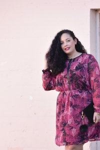 Girl With Curves blogger Tanesha Awasthi wears a long sleeve floral print plus size mini dress.