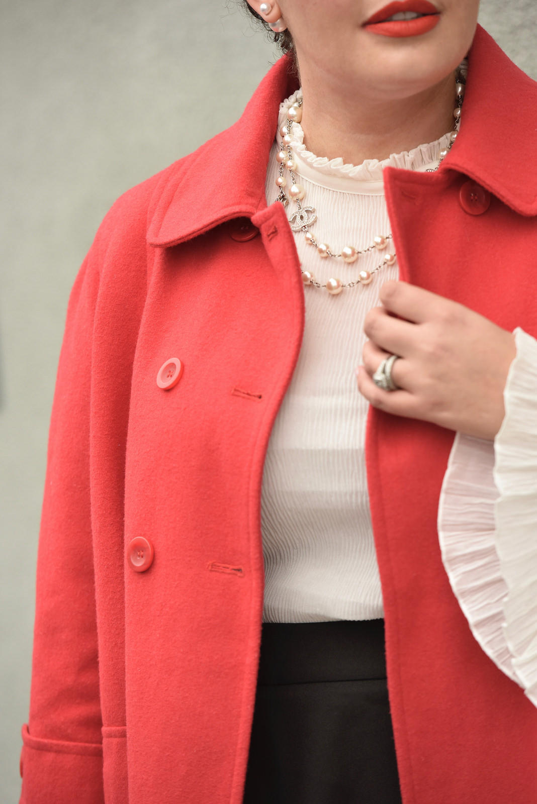 Girl With Curves blogger Tanesha Awasthi wears a bell sleeve blouse, red swing coat and Chanel necklace.