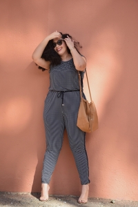 Girl With Curves blogger Tanesha Awasthi wears a Michael Kors jumpsuit.