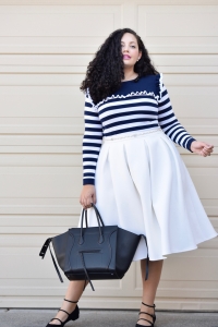 Girl With Curves blogger Tanesha Awasthi wears a stripe ruffle sweater, midi skirt, strappy flats and Celine Phantom bag.