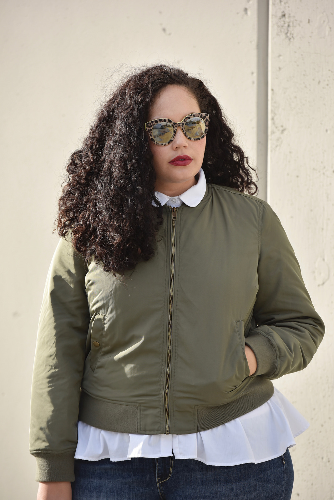 Girl With Curves blogger Tanesha Awasthi wears a satin bomber jacket, peplum top and skinny jeans.