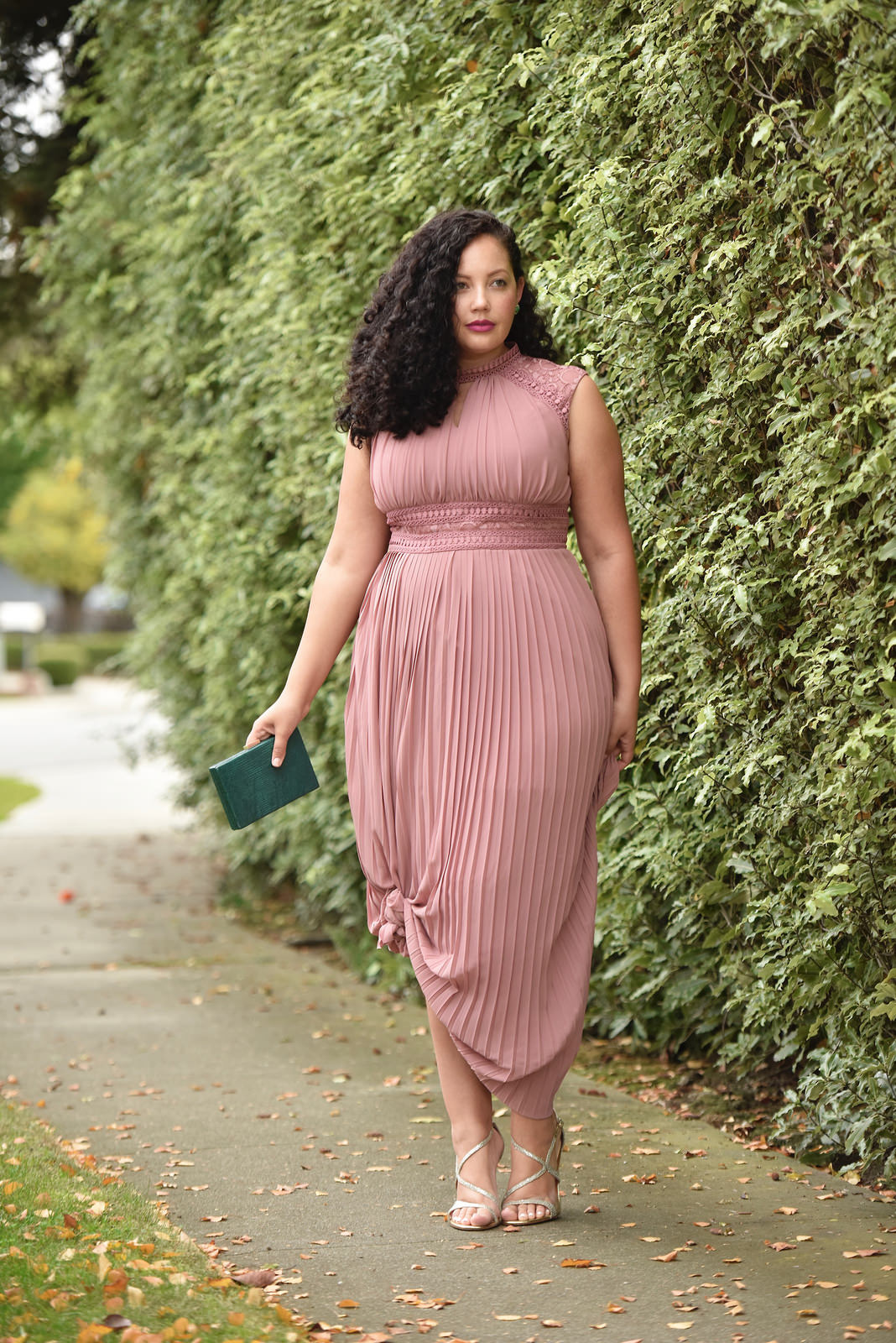 Girl With Curves blogger Tanesha Awasthi wears a lace detail plus size maxi dress and emerald accessories.