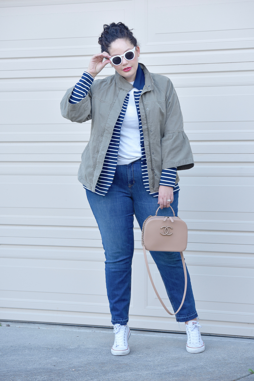 Girl With Curves blogger Tanesha Awasthi wears a utility jacket, boyfriend jeans and converse.