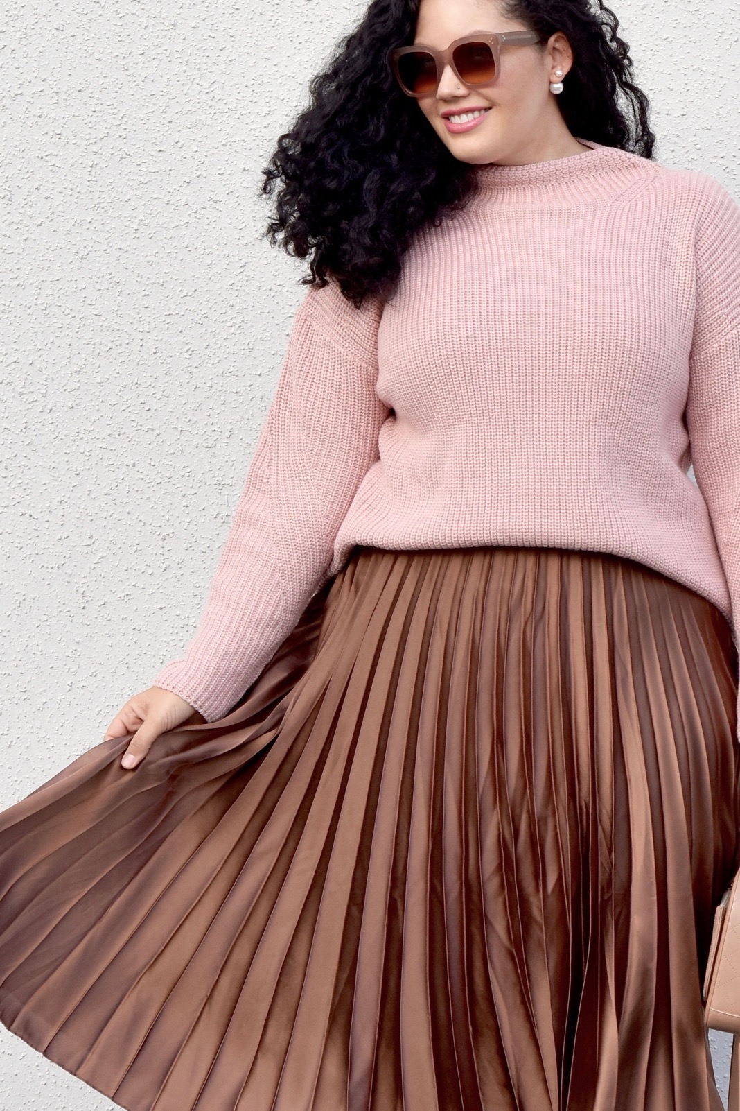 Girl With Curves blogger Tanesha Awasthi wears a Satin Skirt and high neck sweater.