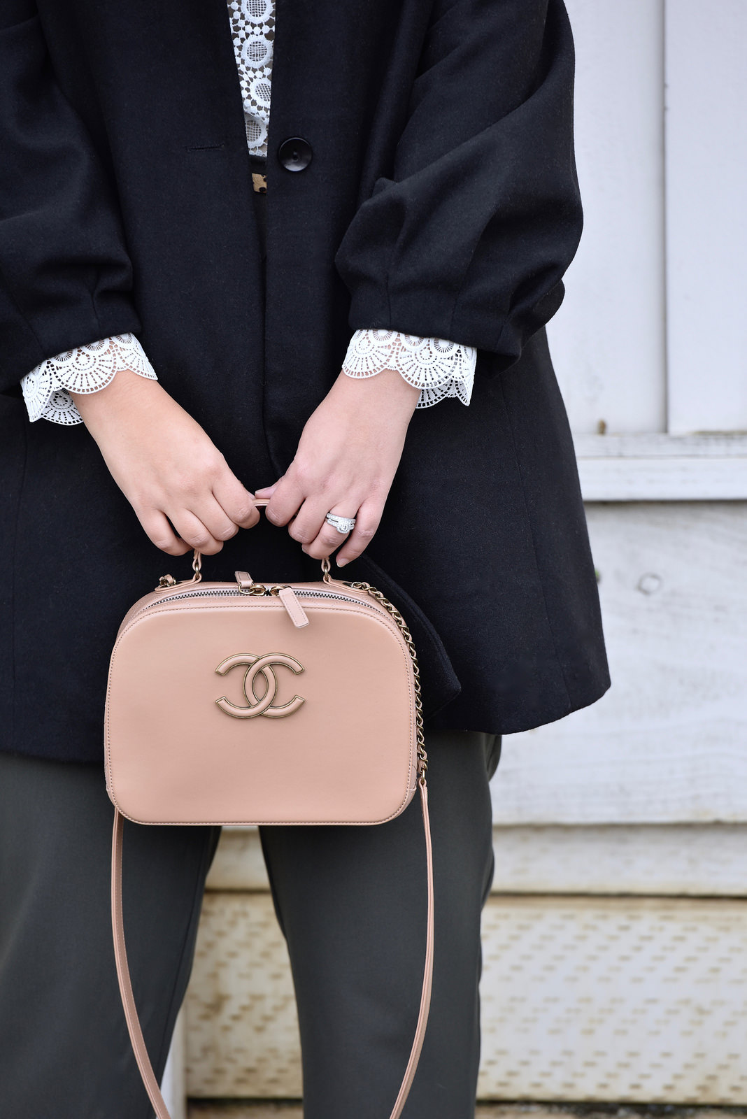 Girl with Curves blogger Tanesha Awasthi holding a Chanel Purse.